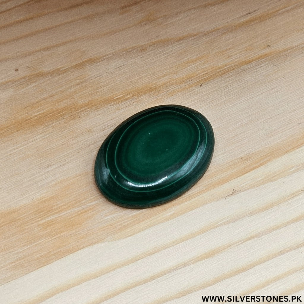 SilverStones.Pk oval real malachite stone with vibrant green swirls, believed to aid kidney health.