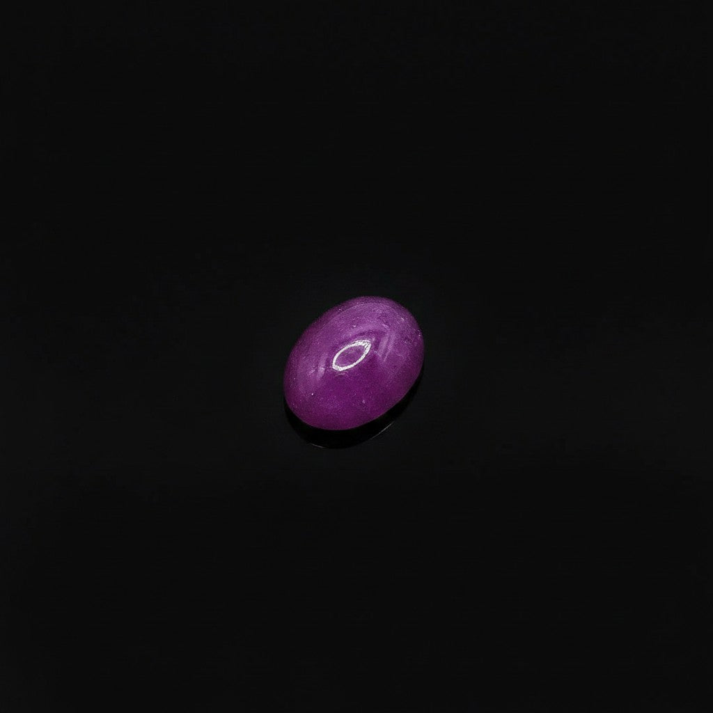 SilverStones.Pk oval cabochon cut real ruby star stone, deep red with a visible six-rayed star pattern.