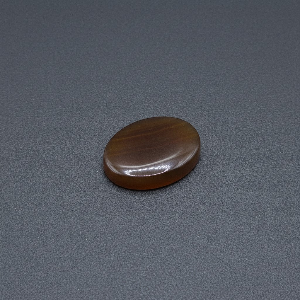 SilverStones.Pk real Sulemani Aqeeq stone, oval cabochon, deep brown with lighter banding, polished finish.