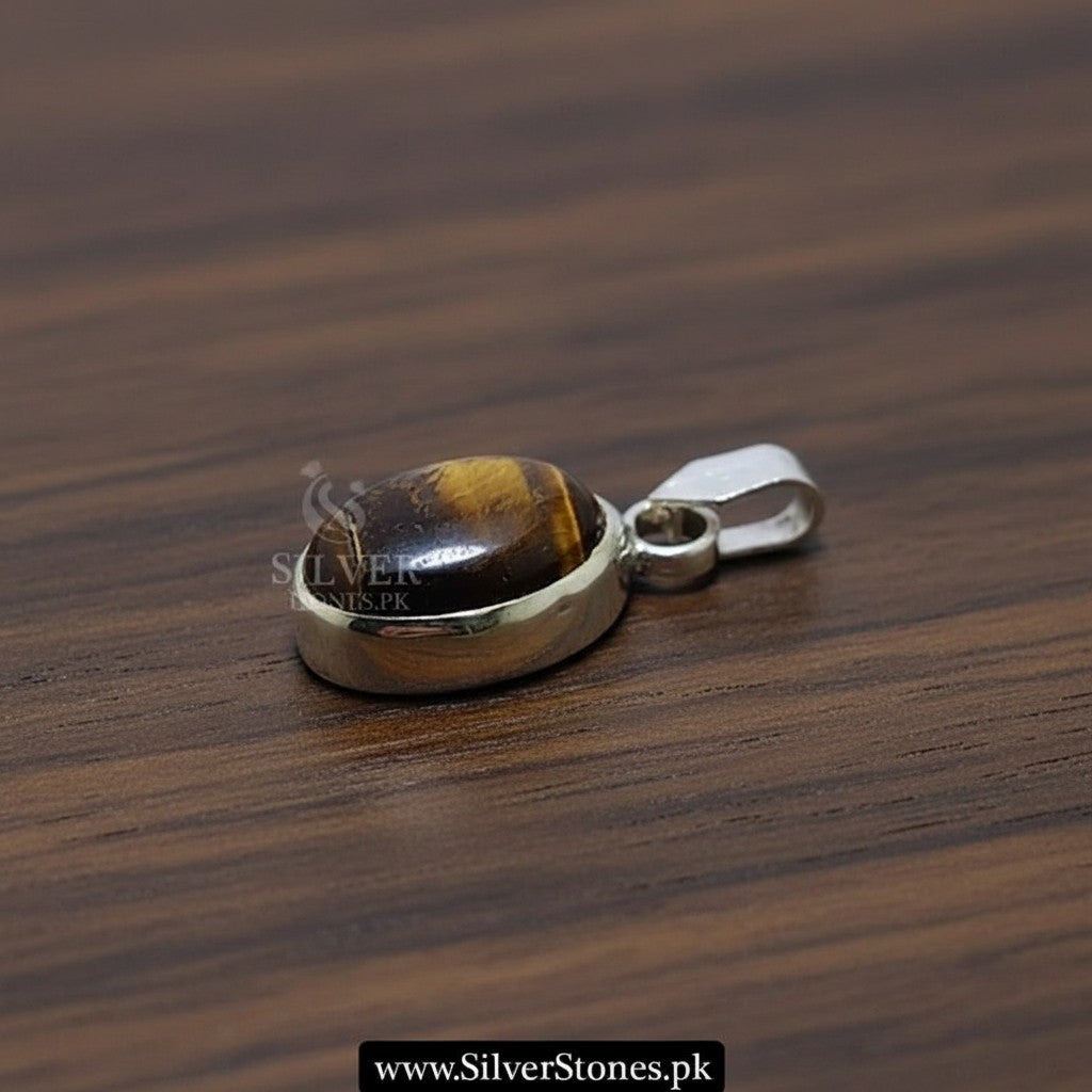 SilverStones.Pk real tiger eye chandi pendant with a polished silver bail. Features a cabochon cut tiger eye stone with golden brown bands.