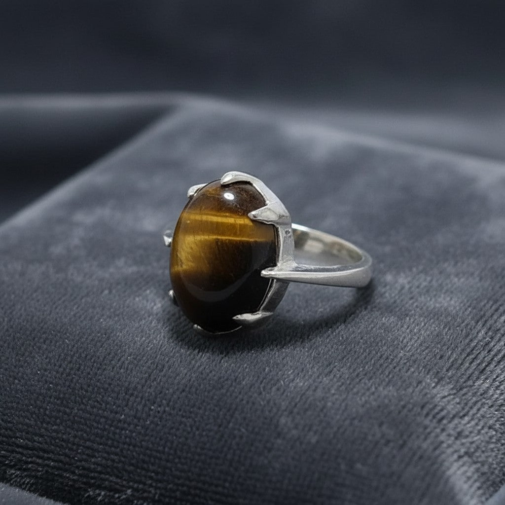 SilverStones.Pk ladies ring with a real tiger stone gemstone. Oval-cut brown and gold banded tiger eye set in a silver band.