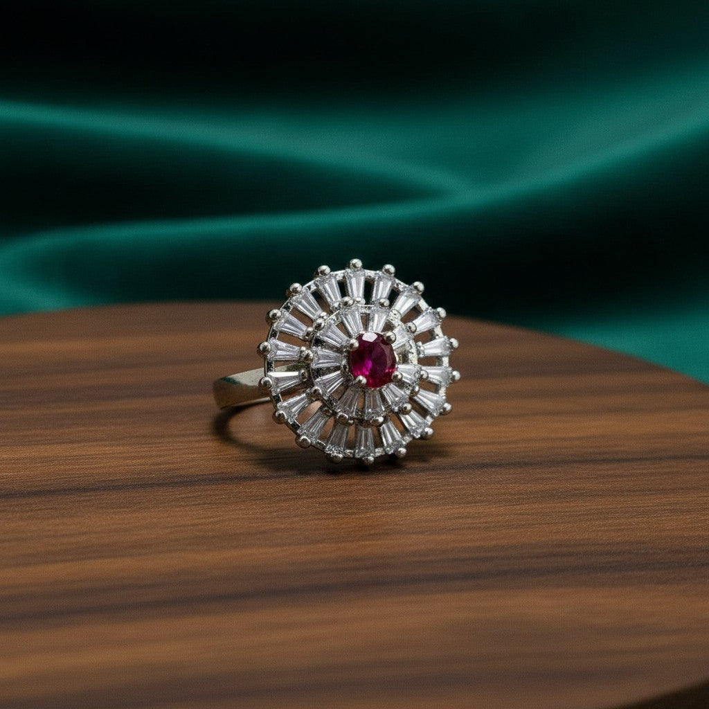 SilverStones.Pk A+ quality imitation ring with a central red zircon stone surrounded by baguette and round clear zircon stones.