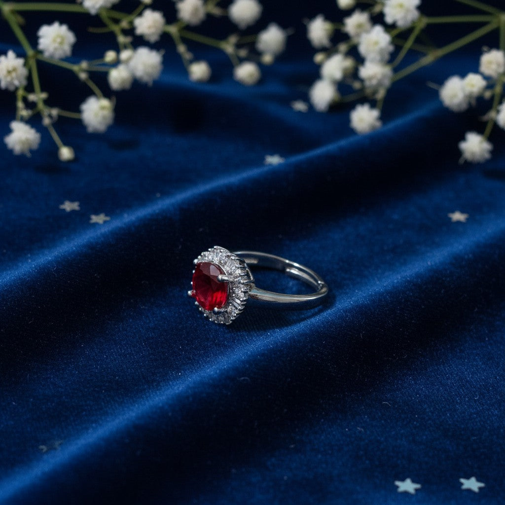 SilverStones.Pk elegant ladies ring with a large red zircon center stone surrounded by small clear zircon stones.