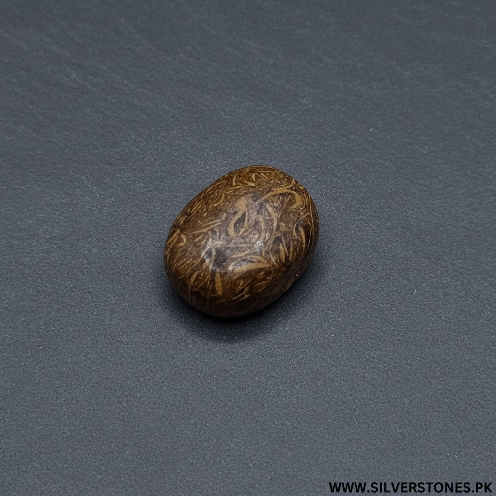 SilverStones.Pk Real Sang-e-Mariam stone, a polished, oval, brown, and tan gemstone with natural swirling patterns, believed to offer spiritual protection and healing.