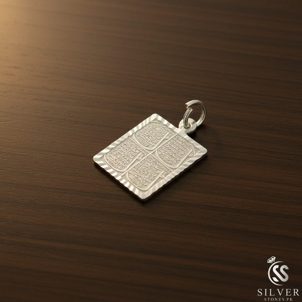 SilverStones.Pk Islamic silver pendant featuring Arabic calligraphy of the four Quls, set against a green grass background.