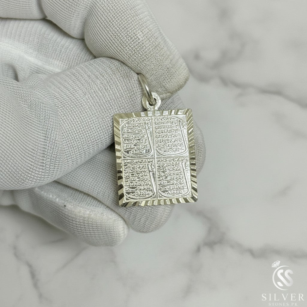 SilverStones.Pk Islamic silver pendant featuring Arabic calligraphy of the four Quls, set against a green grass background.
