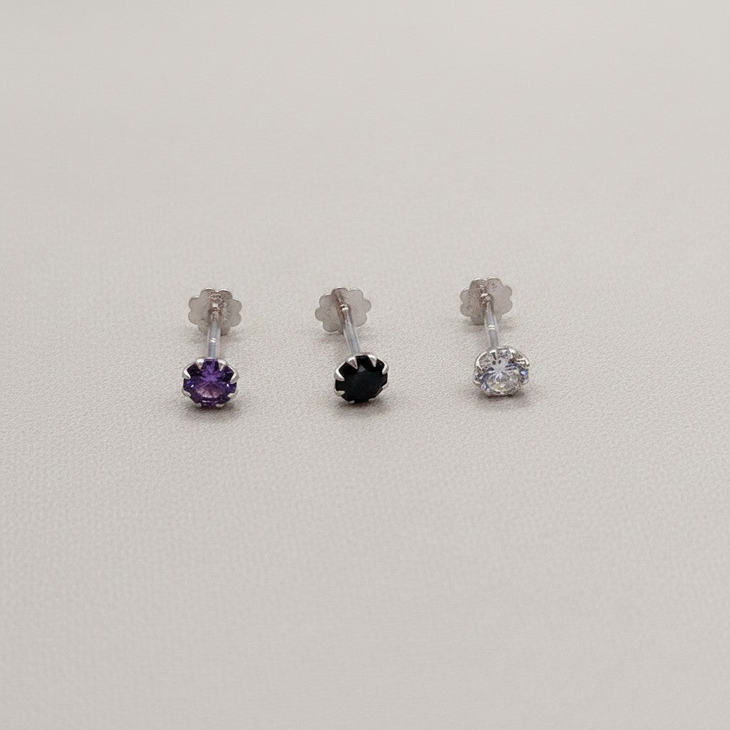 SilverStones.Pk pack of 3 silver nose pins with purple, black, and clear zircon stones.