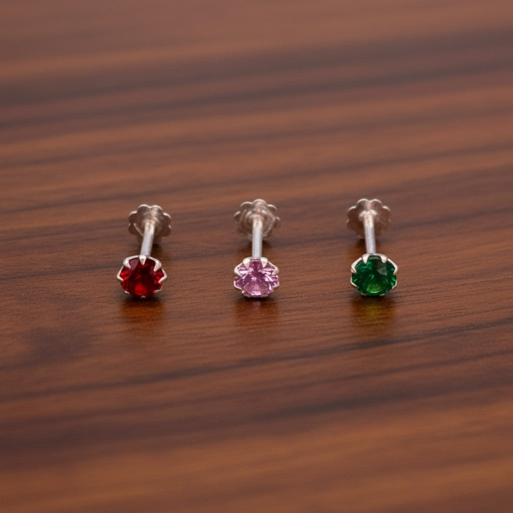 SilverStones.Pk pack of 3 silver nose pins with red, pink, and green zircon stones, 4mm stone size, secure fit for everyday wear.