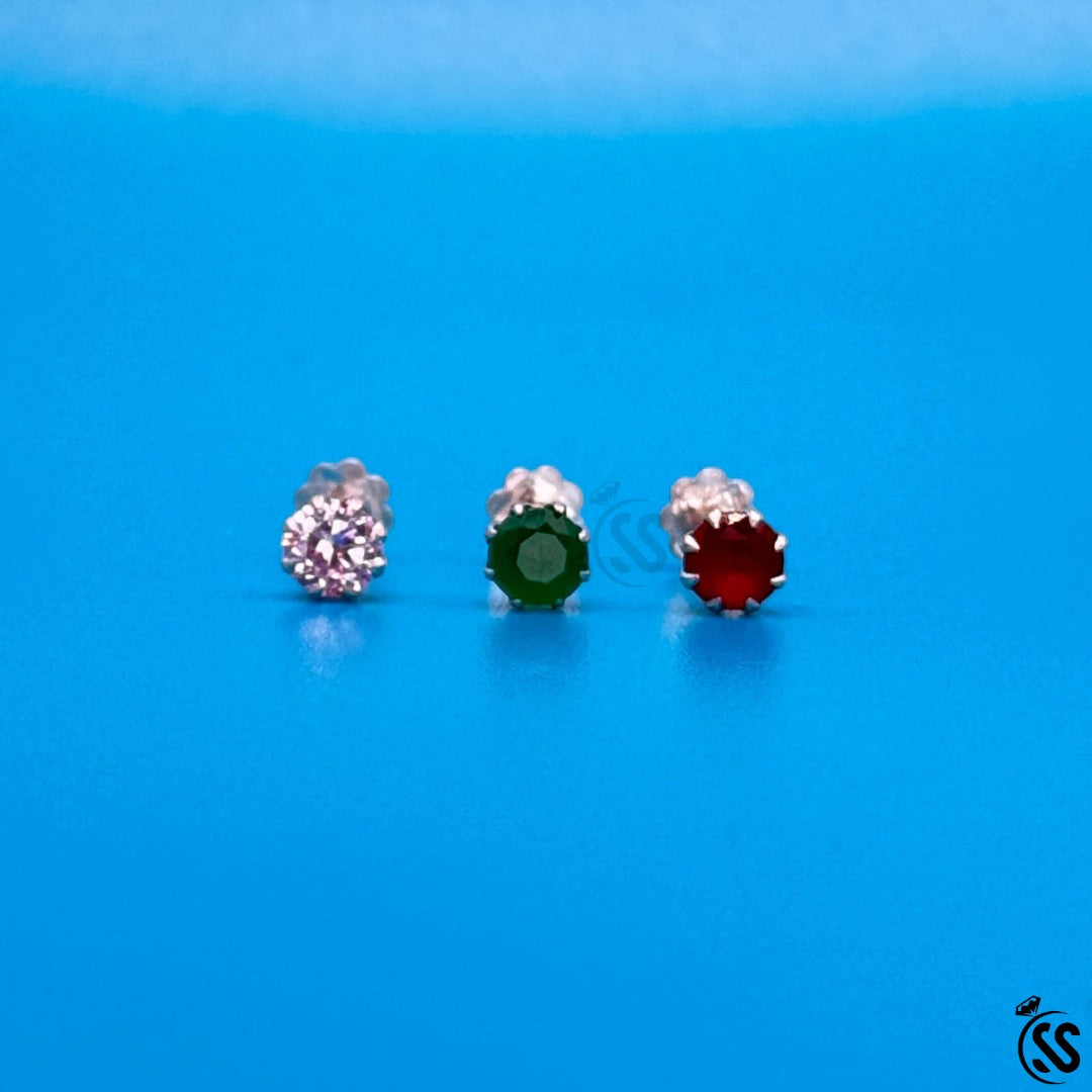 SilverStones.Pk pack of 3 sterling silver nose pins with sparkling zircon stones in pink, green, and red.