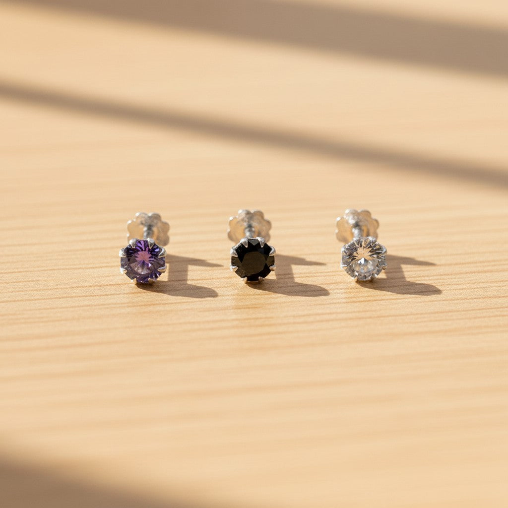 SilverStones.Pk pack of 3 silver nose pins with purple, black, and clear zircon stones.