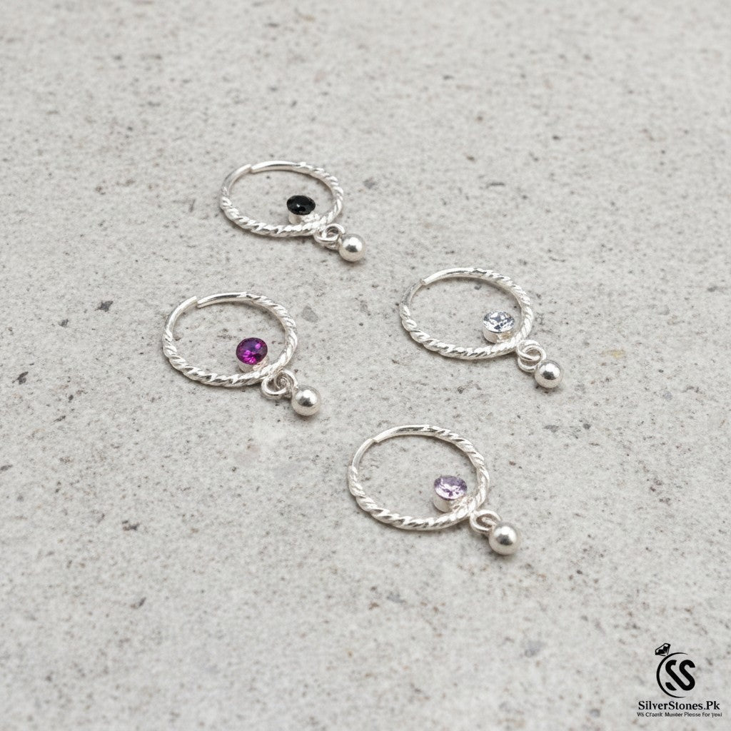 SilverStones.Pk sterling silver nose ring with a dangling bead and a sparkling zircon stone. Available in black, purple, and clear.