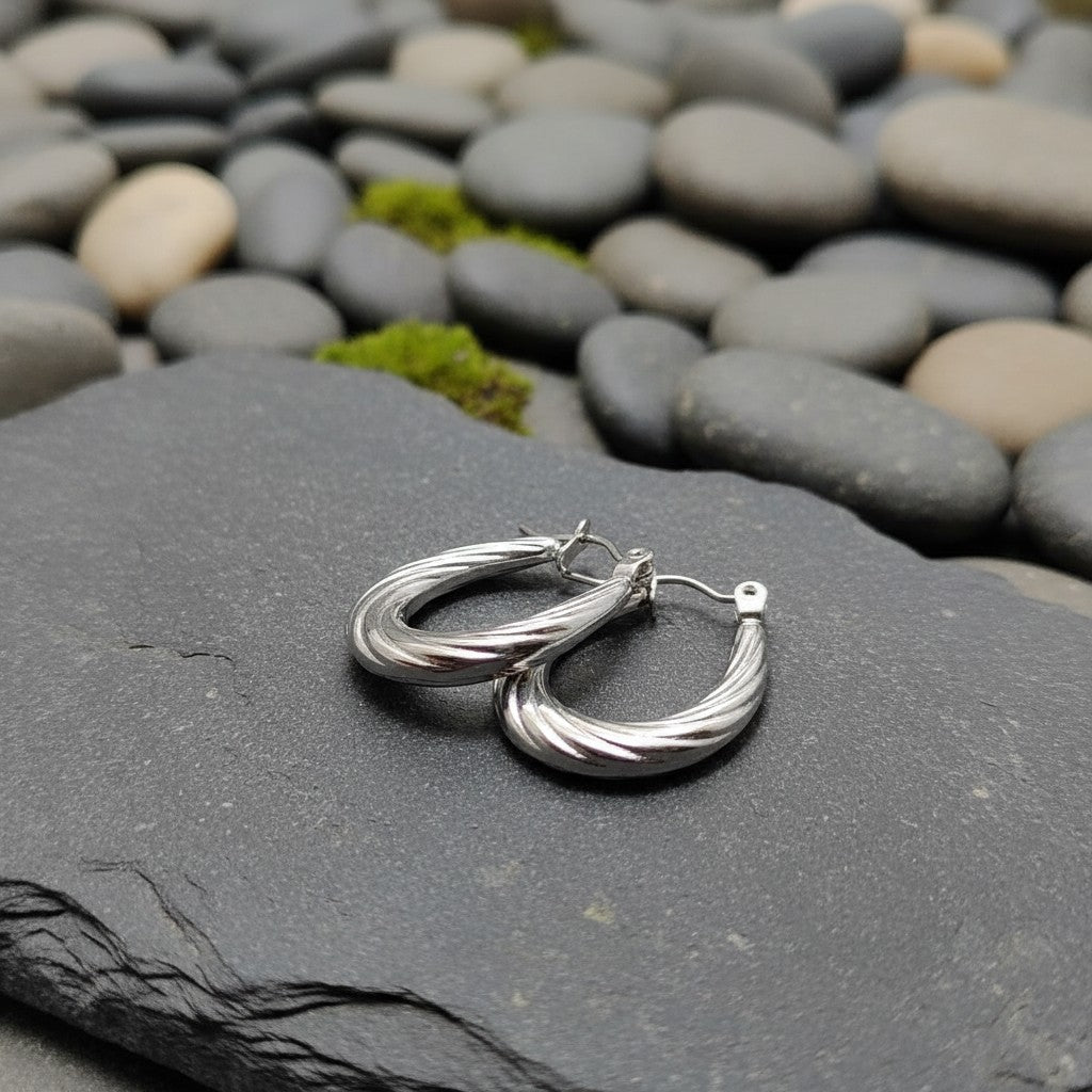 SilverStones.Pk elegant silver color oval hoop earrings with twisted design, suitable for parties and daily wear.