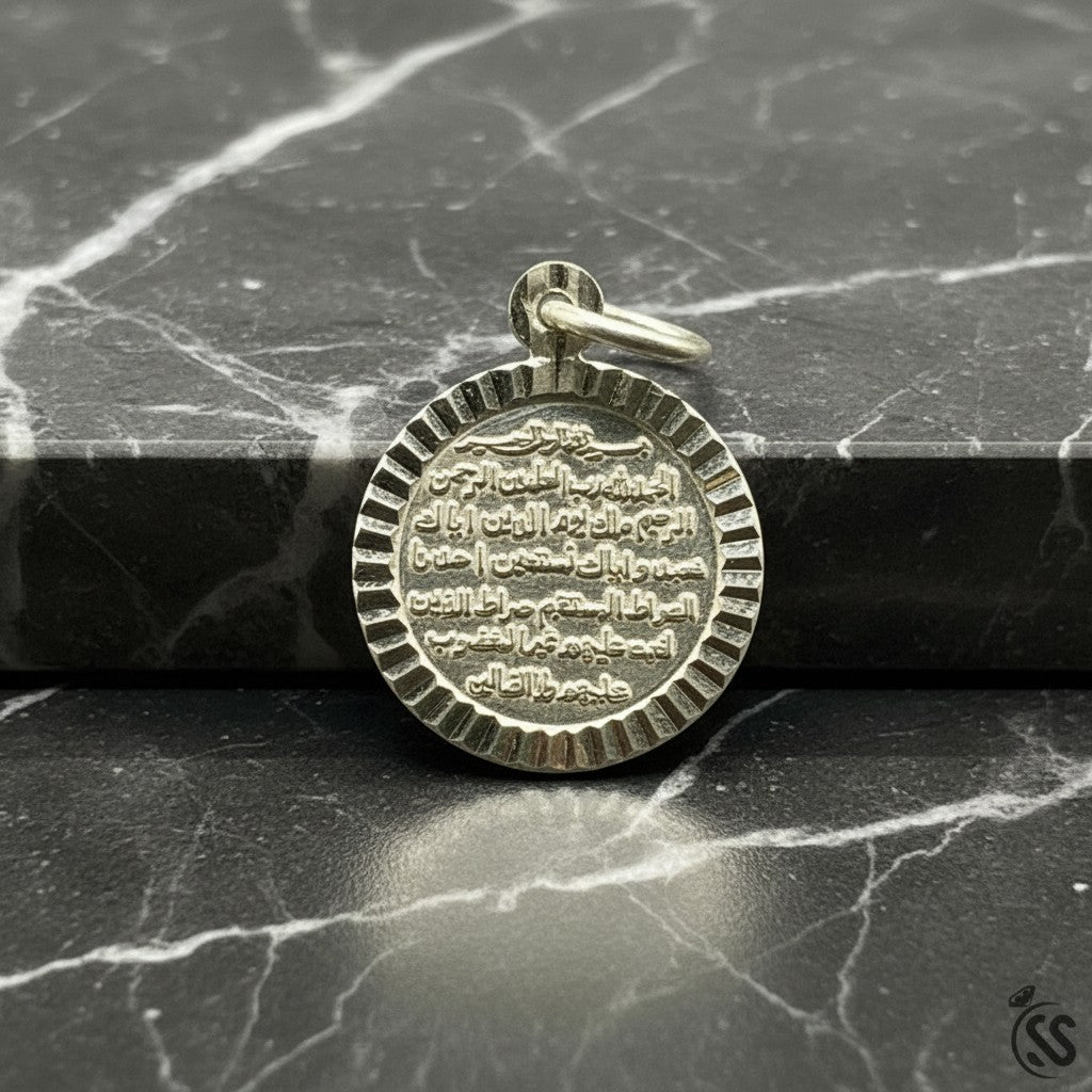 SilverStones.Pk silver pendant with engraved Surah Rehman text. Round, detailed Islamic jewelry.