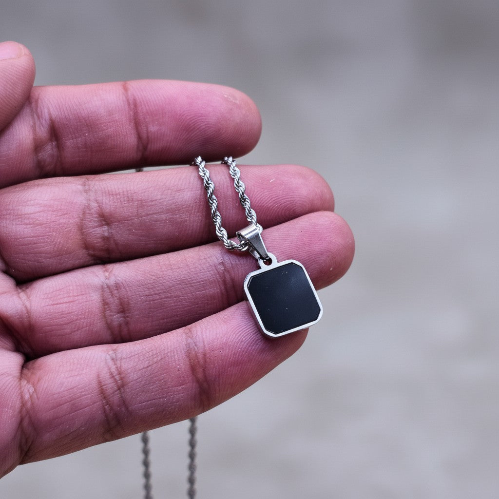 SilverStones.Pk men's stainless steel pendant with black inlay on a rope chain. Durable and stylish.
