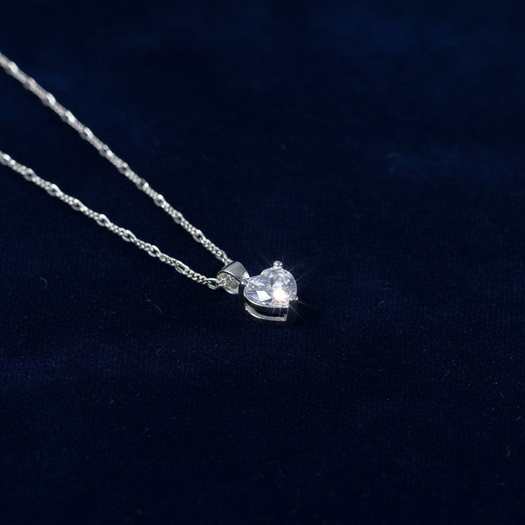 SilverStones.Pk sterling silver heart pendant necklace with clear zircon on a Figaro chain.