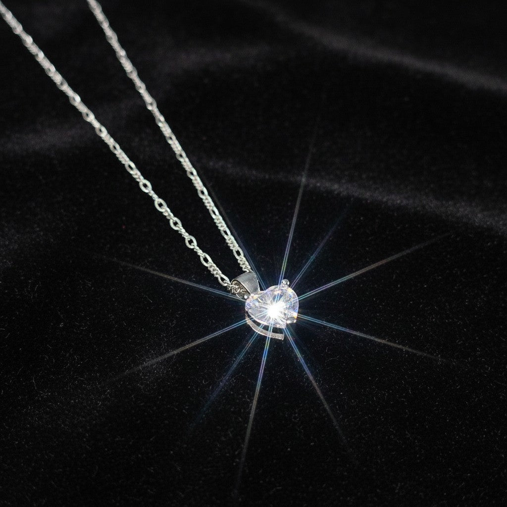SilverStones.Pk sterling silver heart pendant with clear zircon on a Figaro chain.