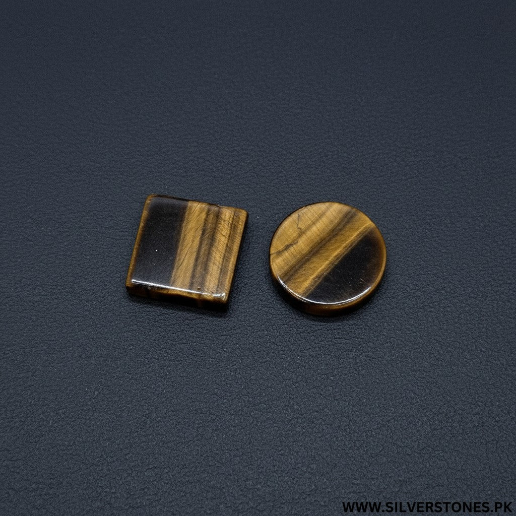 SilverStones.Pk real tiger eye stones, one square and one round, showcasing golden-brown bands and chatoyancy.