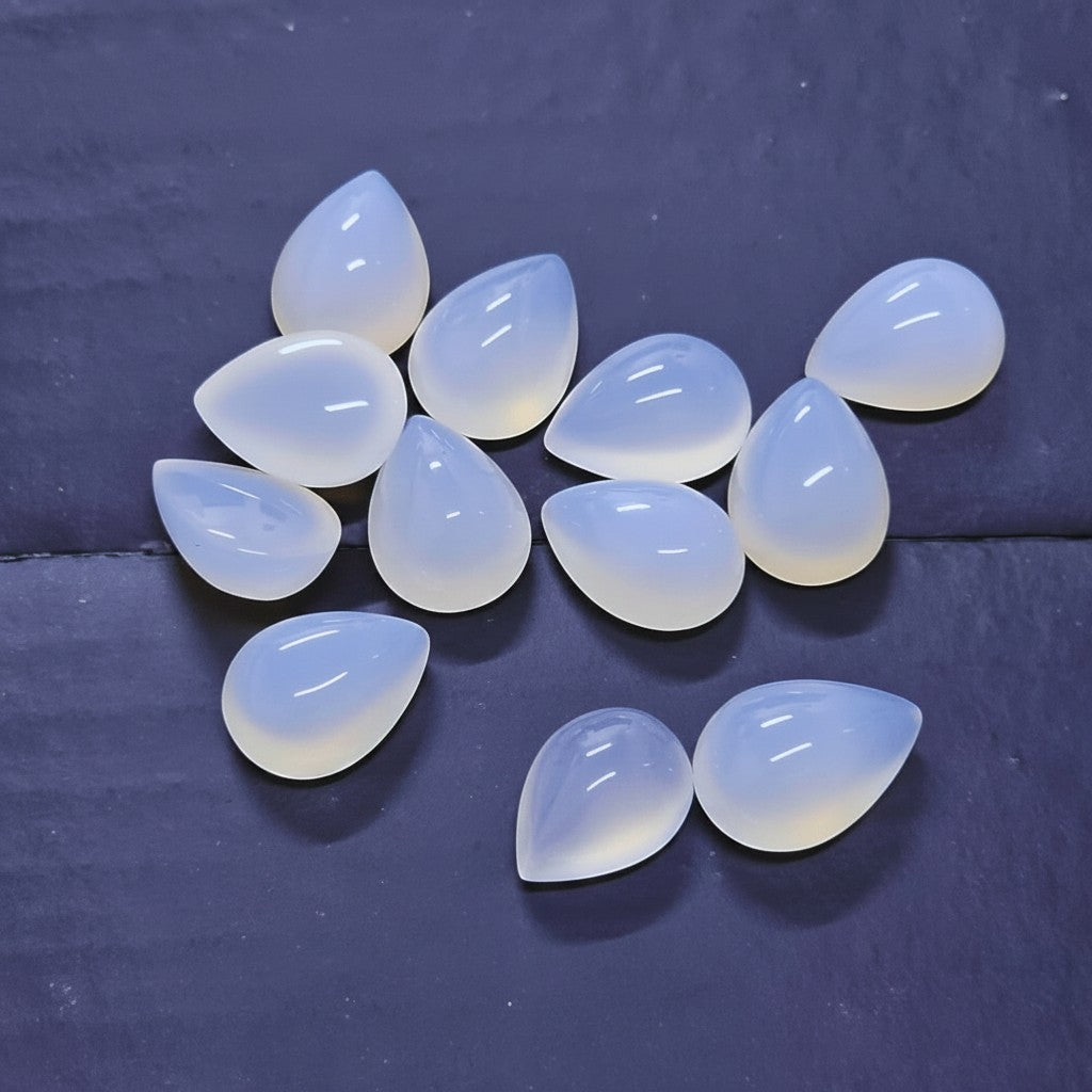 SilverStones.Pk real white aqeeq stones, teardrop shape, translucent with subtle banding, ideal for jewelry.