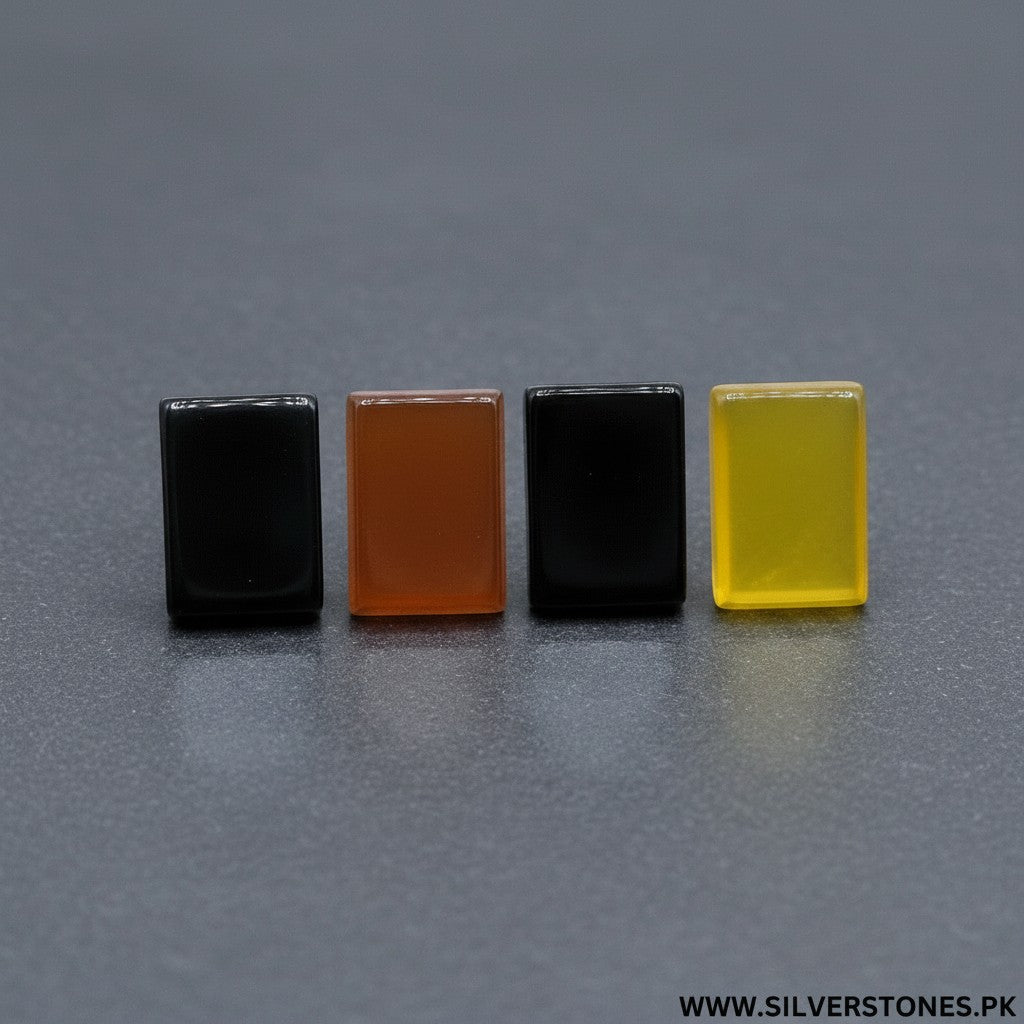 SilverStones.Pk collection of four rectangular Yamni Aqeeq stones in black, amber, black, and yellow.