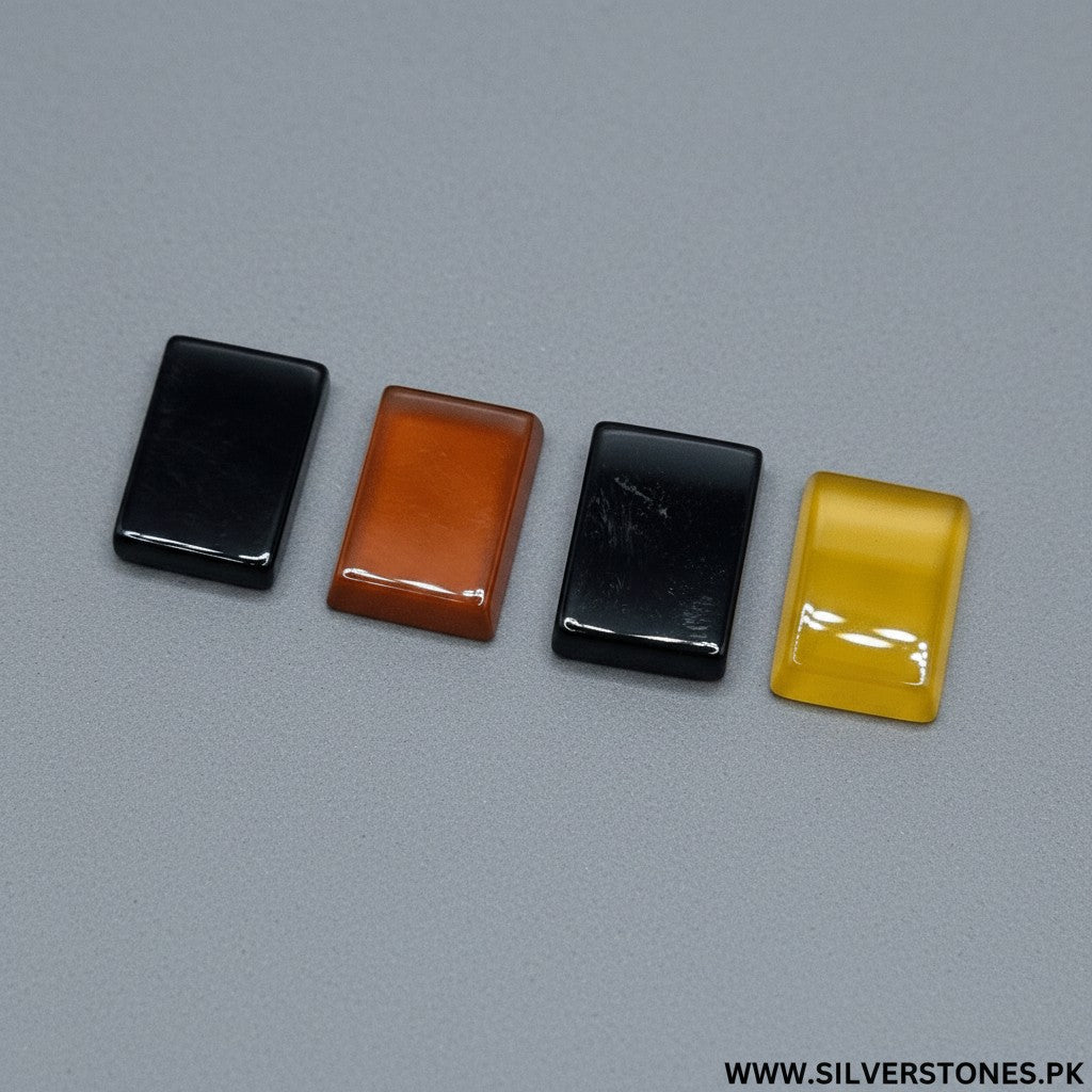 SilverStones.Pk Real Yamni Aqeeq stones in black, orange, and yellow, rectangular cabochon cut, polished finish.