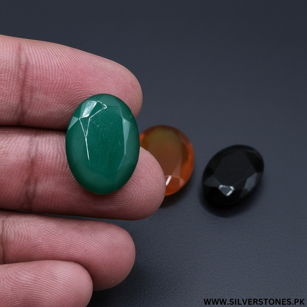 SilverStones.Pk oval cut green, orange, and black Yamni Aqeeq stones, symbols of spiritual power and protection.