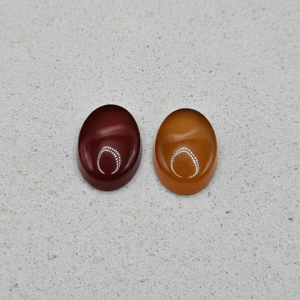 SilverStones.Pk oval cabochon Yamni Aqeeq stones in deep red and warm orange, ideal for jewelry.