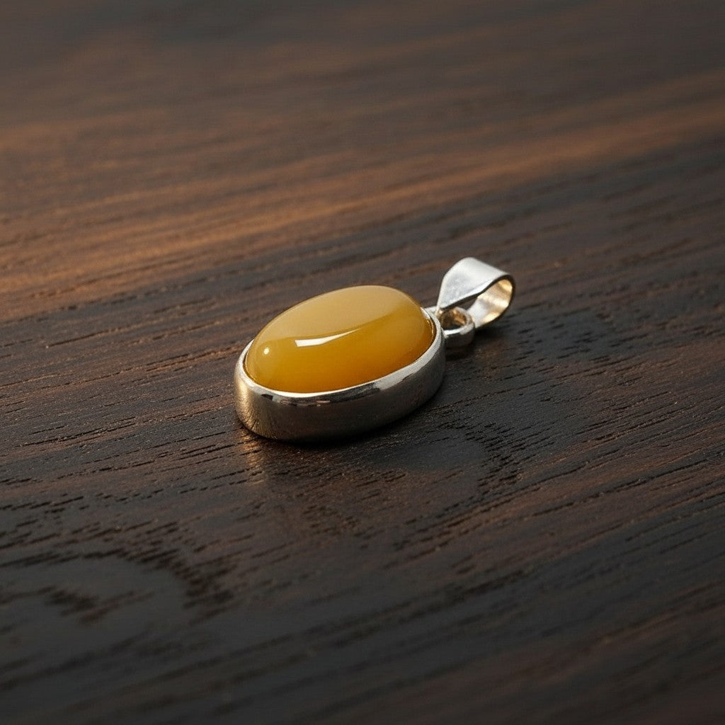 SilverStones.Pk oval yellow aqeeq stone pendant with silver bezel and bail. A symbol of strength and protection.