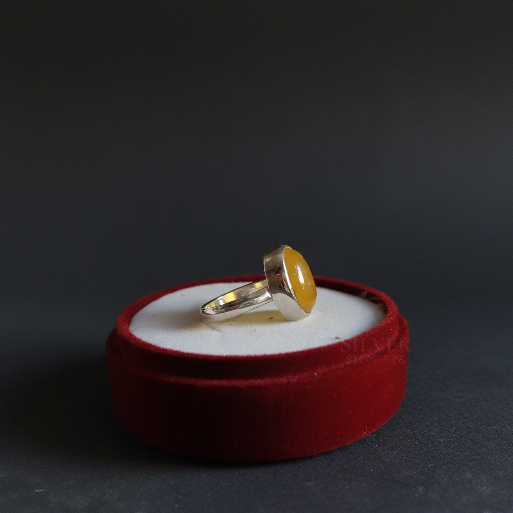 SilverStones.Pk handmade silver ring with a smooth, oval, yellow Aqeeq gemstone. A symbol of strength and protection.