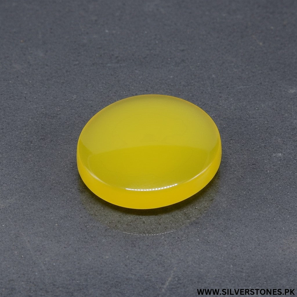 SilverStones.Pk real yellow Aqeeq Yamni stone, round shape, 29.55 carats, vibrant golden-yellow hue, smooth polished finish.