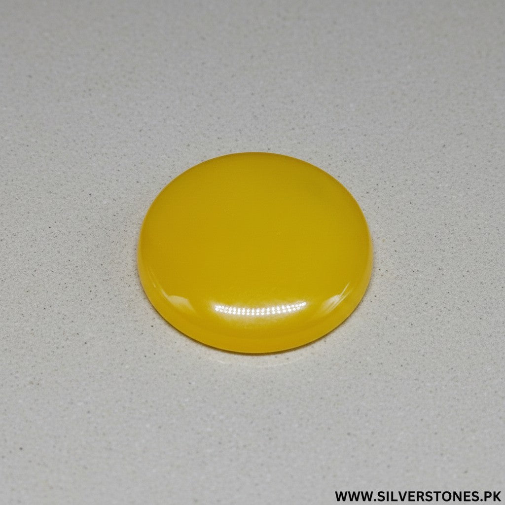 SilverStones.Pk real yellow Aqeeq Yamni stone, round shape, 29.55 carats, vibrant golden-yellow hue, smooth polished finish.